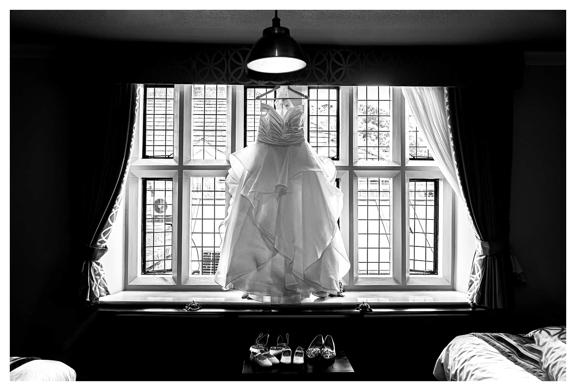 wedding dress photograph, wedding dress hanging in rogerthorpe manor window