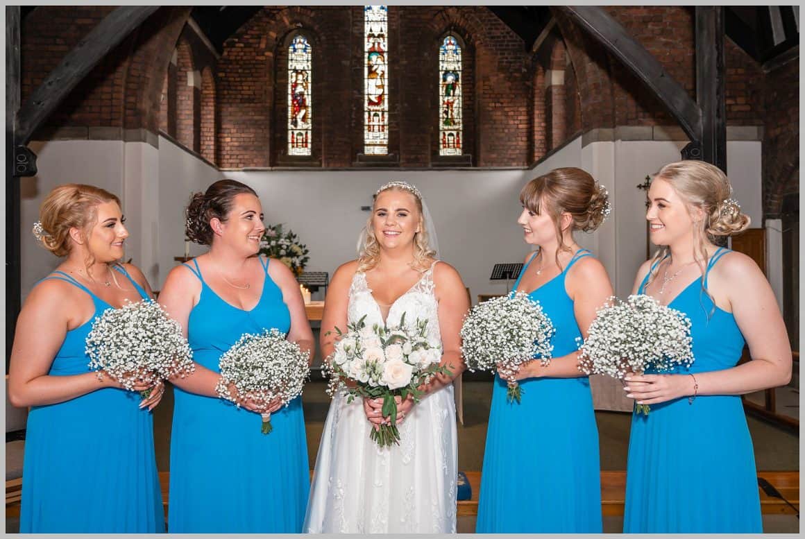 Picture of bride and bridesmaids posing for a picture inside  ST. ANNE'S CHURCH WRENPHOPRE , Wakefield