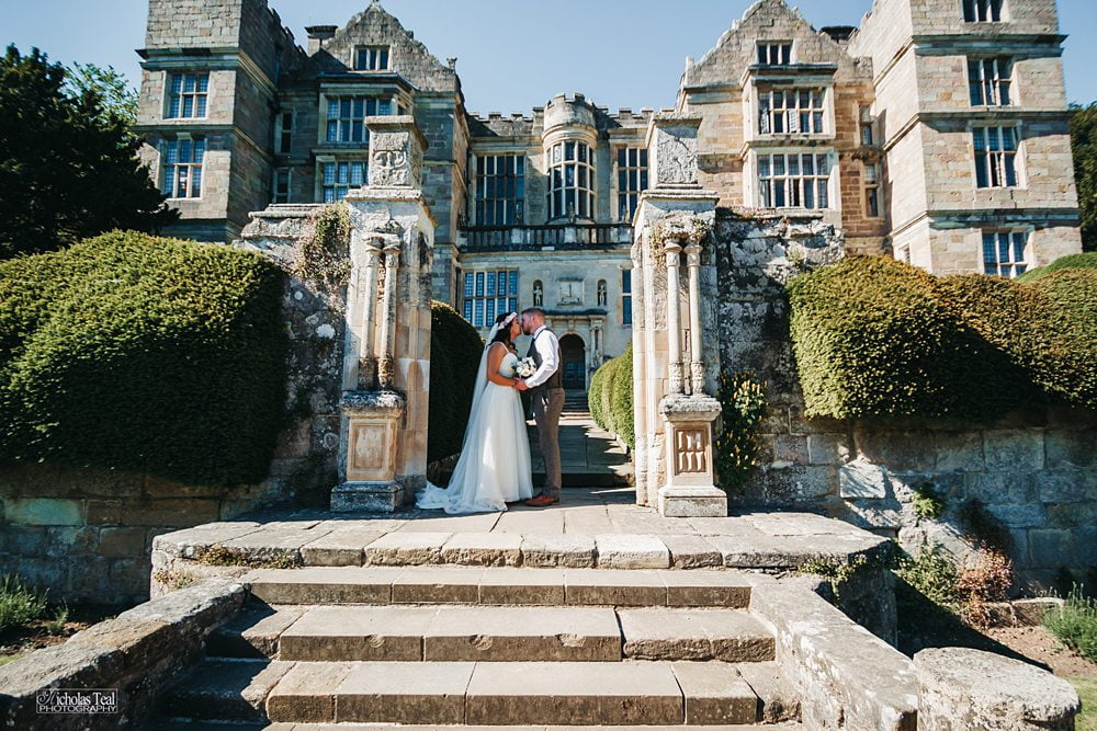 bride and groom pose on steps at Bride and Groom on steps Fountains outside of Hall Fountains Hall Rippon, Fountains Hall Rippon Photos, Fountains Hall Wedding photographer