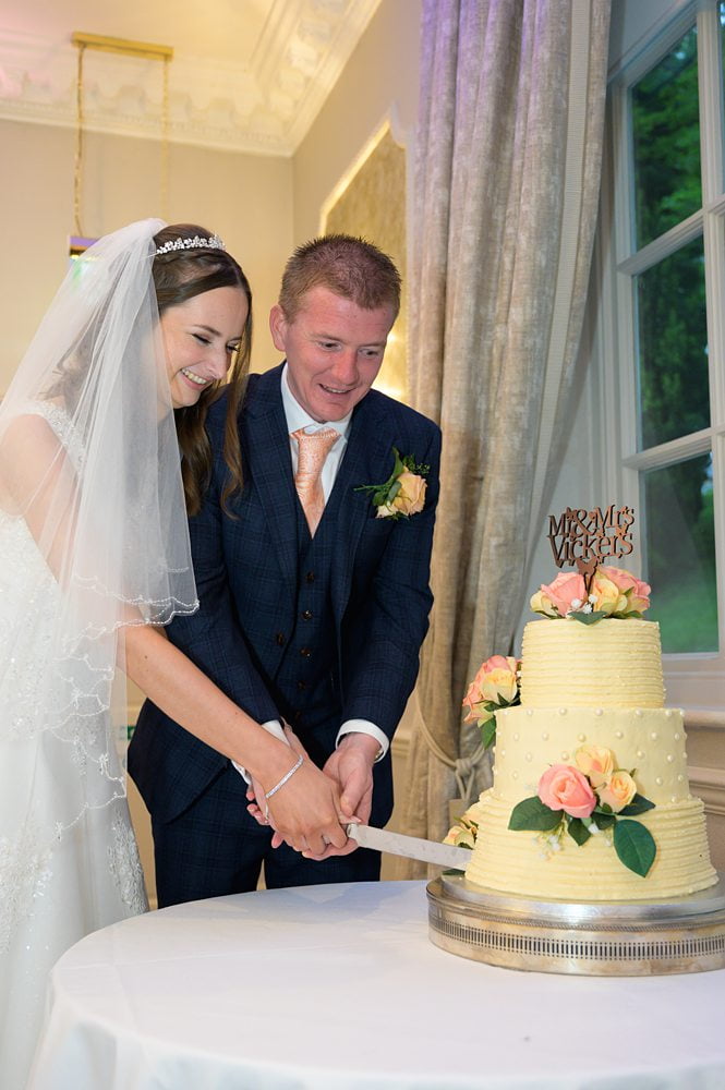 Bride and groom Cake cutting photograph Wood Hall Hotel, Wetherby , wood hall hotel Wetherby wedding photography