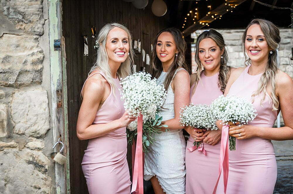 Photograph of Bride and Bridemaids posing inside a wedding barn Wakefield, Wakefield Wedding photographs, Wakefield wedding photographer