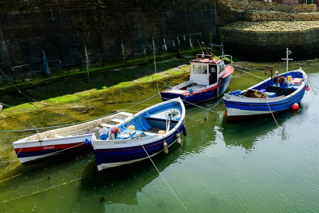 Fishing boats moored in a Yorkshire harbour, evoking a sense of coastal charm and tradition.