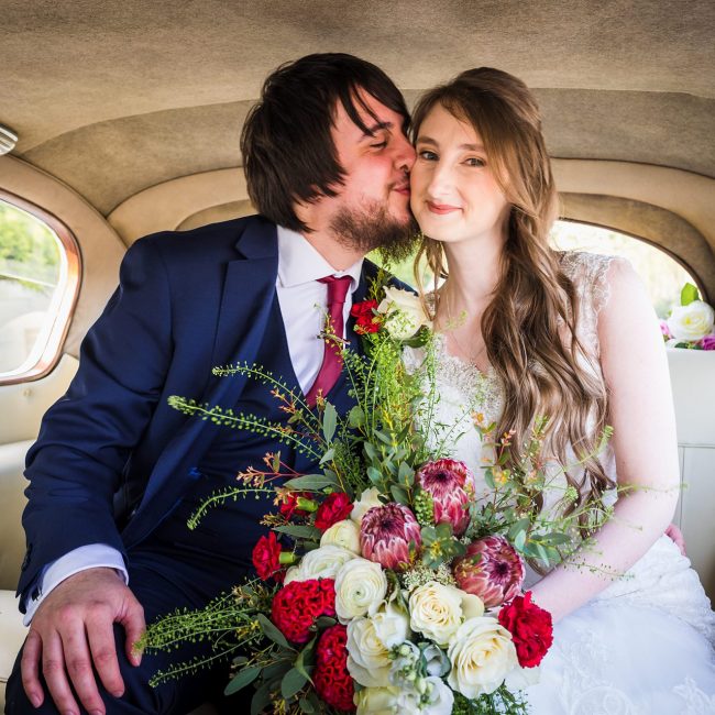 bride and groom kissing in wedding car, Bagden Hall Hotel Denby Dale