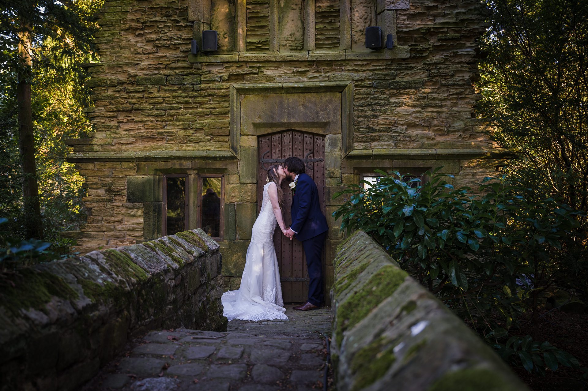 bride and groom posing outside the folly at Bagden Hall