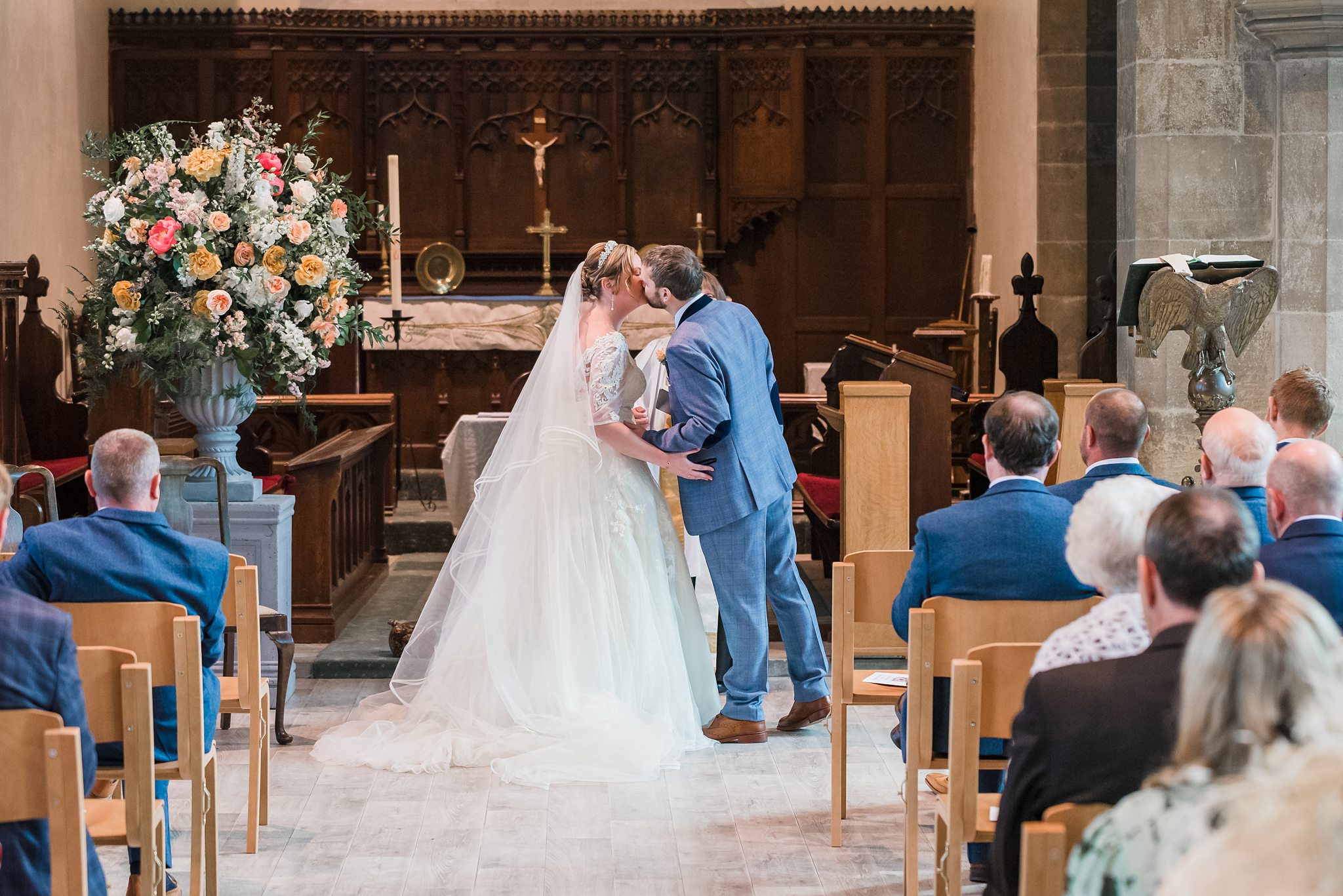 kiss shot of bride and groom kissing at the church