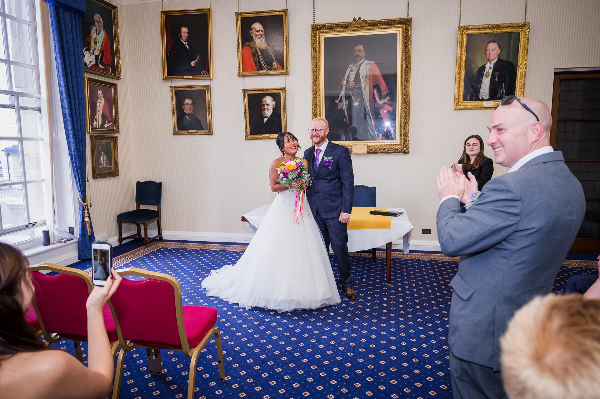 bride and groom getting married inside leeds civic hall