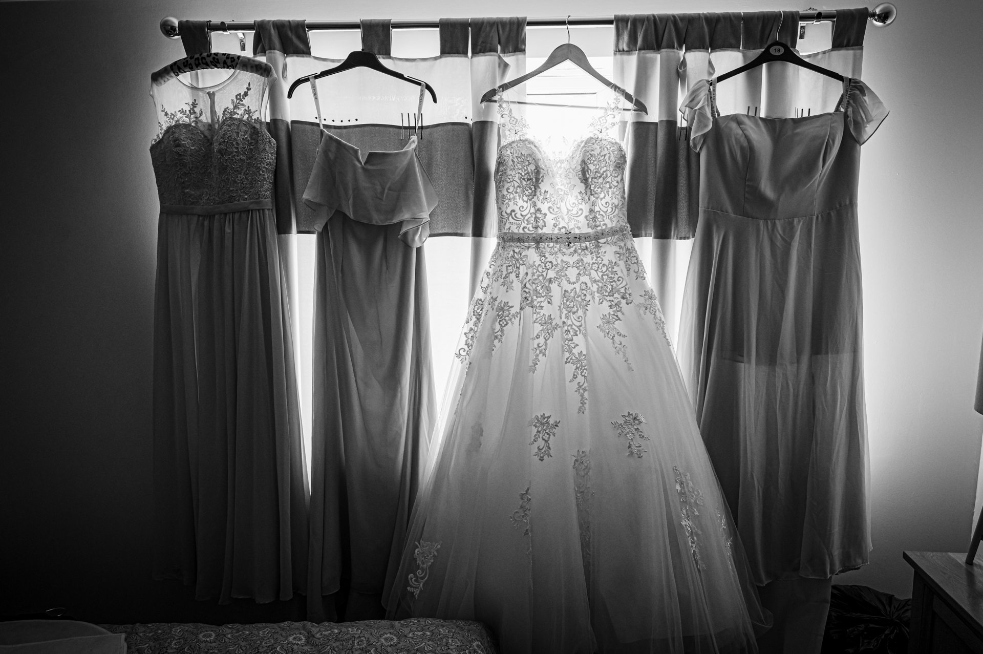 wedding dresses all hanging up in a row