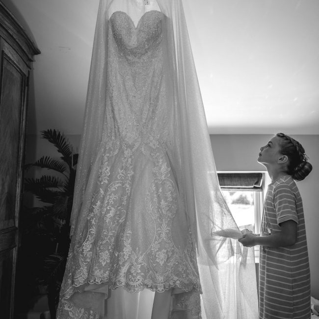 flower girl looking at the wedding dress