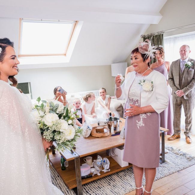 brides mum sees the bride in her wedding dress for the first time