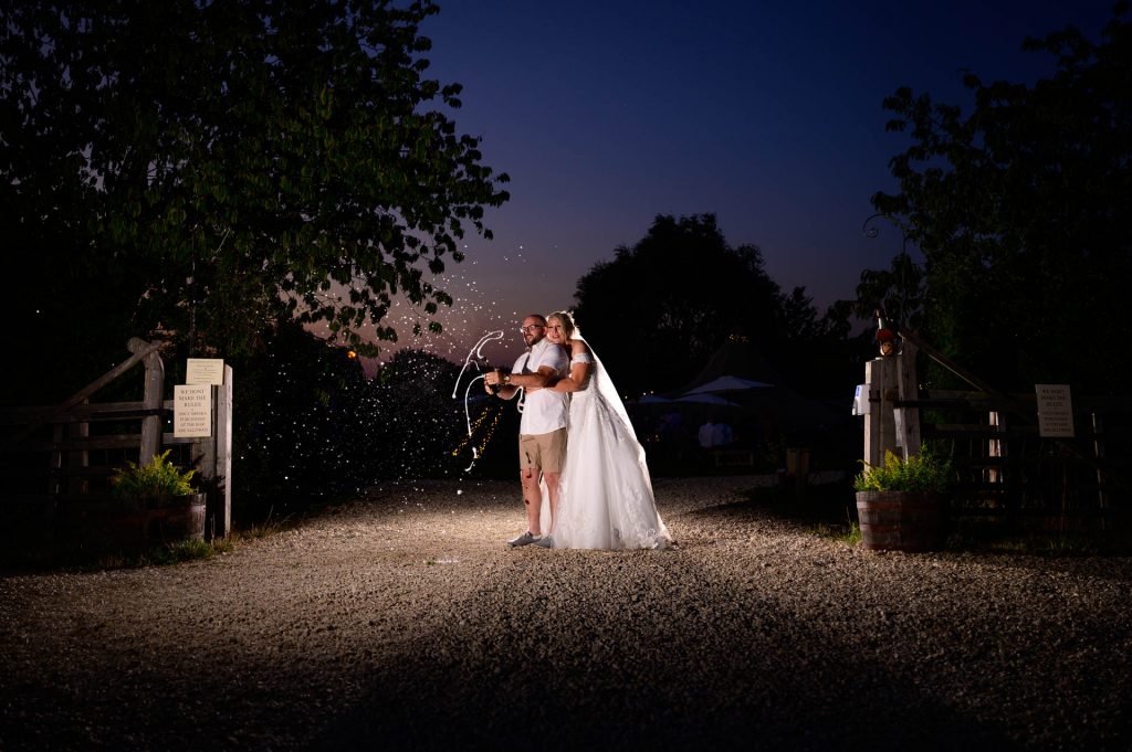 Bride and Groom spraying champagne, Skipbridge Country Weddings, North Yorkshire