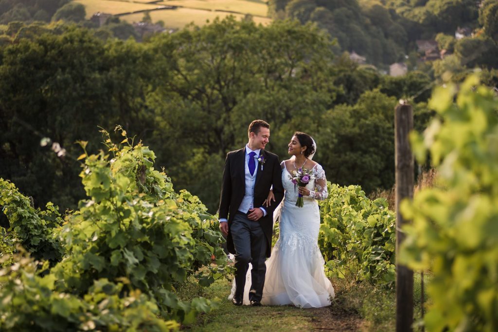 bride and groom walking up the vineyard at Holmfirth vineyard, West Yorkshire wedding photographer