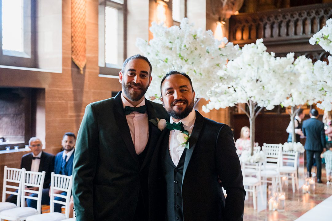 groom and his best man smiling for the camera