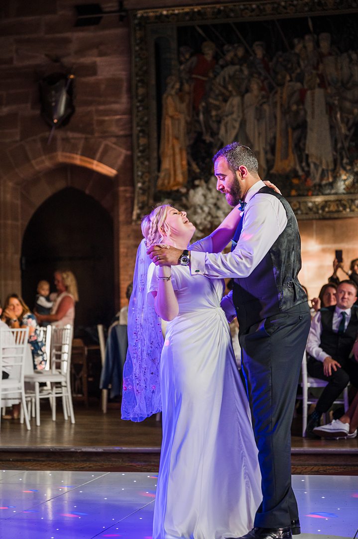 first dance picture of bride and groom dancing in the castle hall