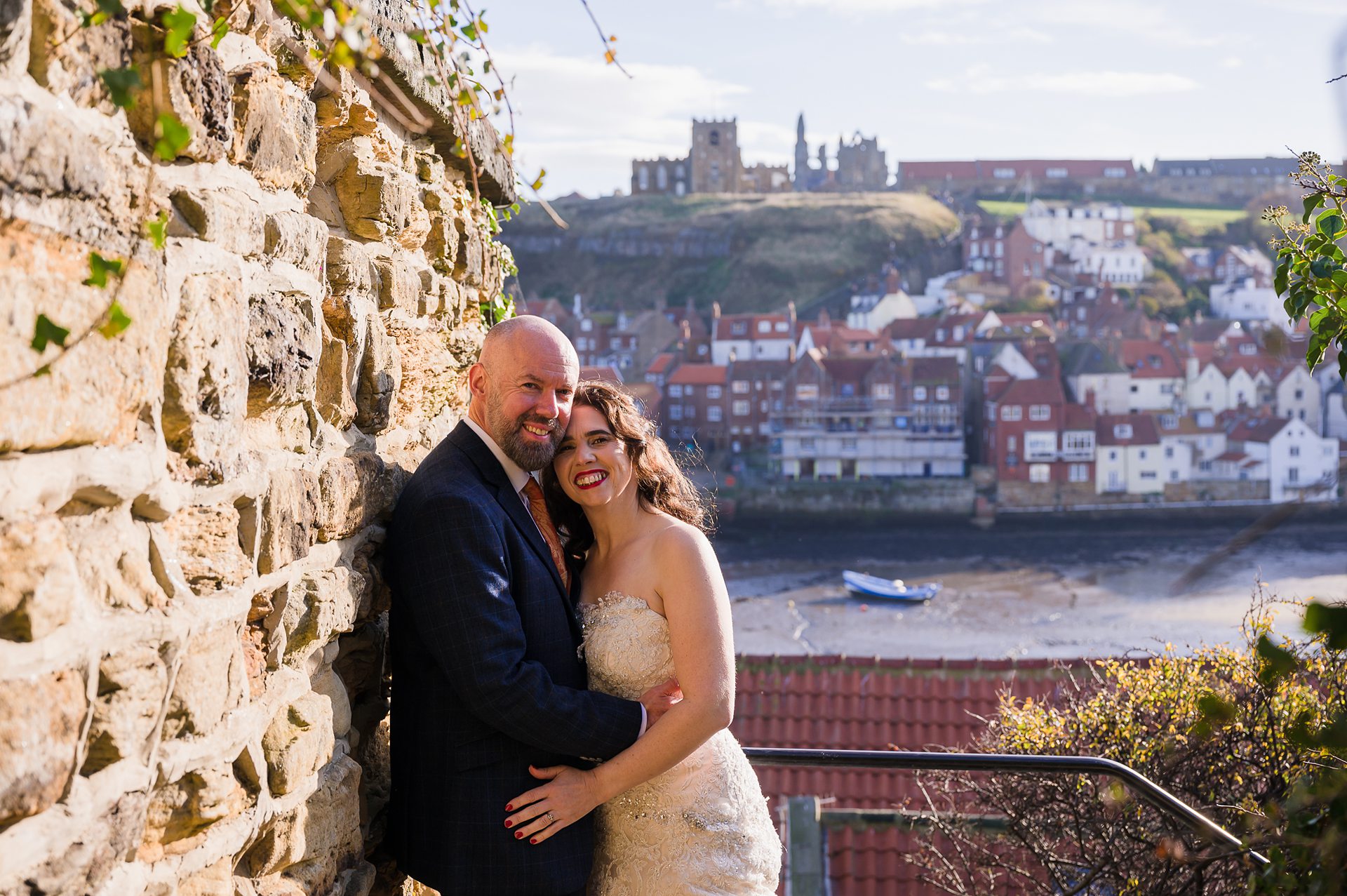 bride and groom portrait next to the Whitby keyhole arch