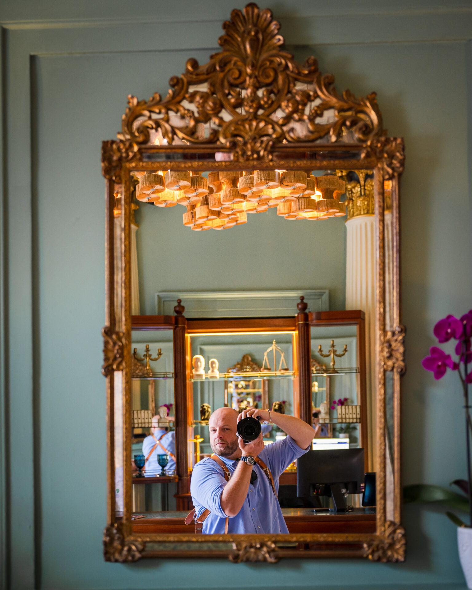 Yorkshire wedding photographer Nicholas takes a mirror selfie in a luxurious venue, capturing his passion.