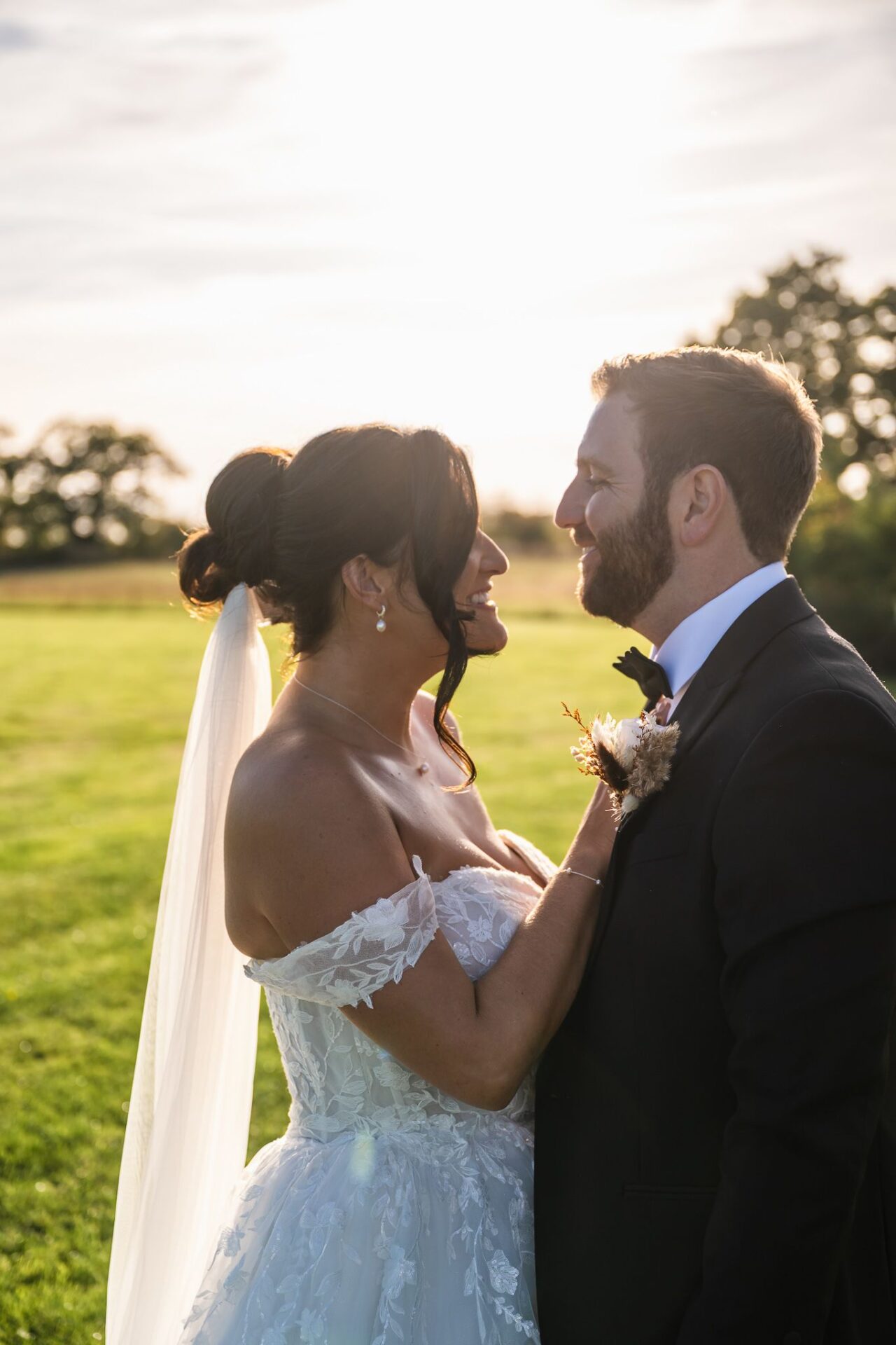 Bride and groom in golden hour light at a luxury Yorkshire wedding venue.