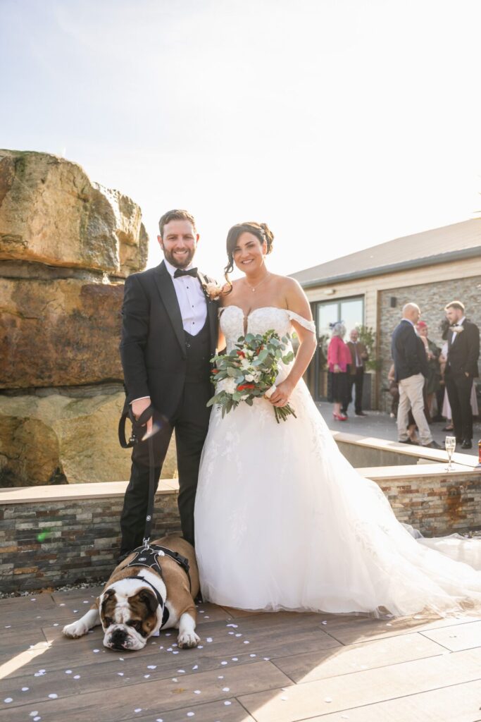 Bride and groom with bulldog at Woodstock Weddings, Yorkshire. Luxury wedding photography.